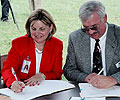Commissioner Burke and Mr Mike Conway sign the State documents of cooperation